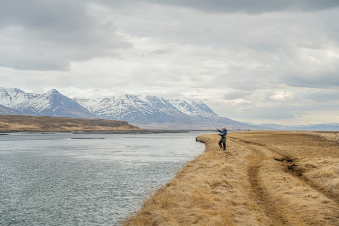 A fisher at river's edge in Iceland.